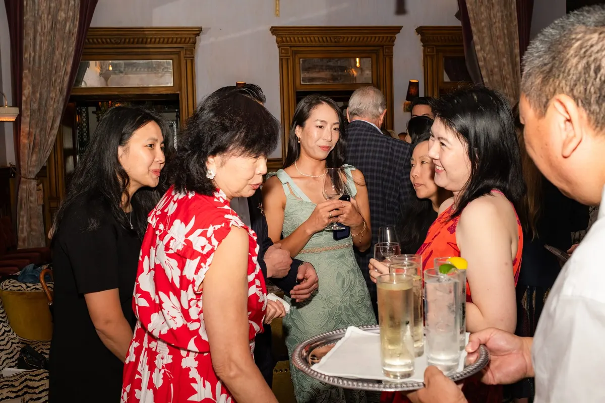 Guests talking as whisky highballs come round