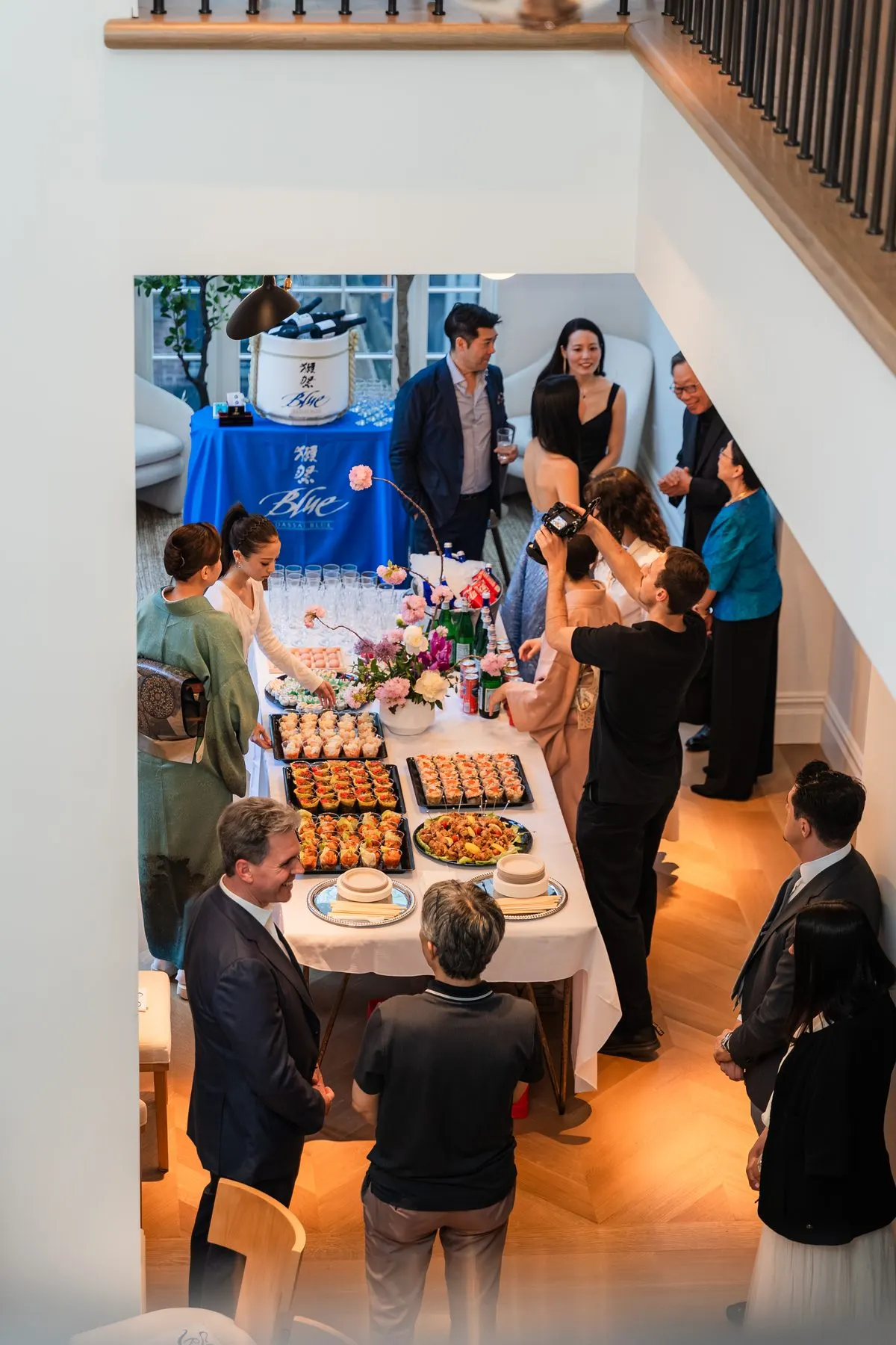 Guests filling the buffet room, seen from the stair landing