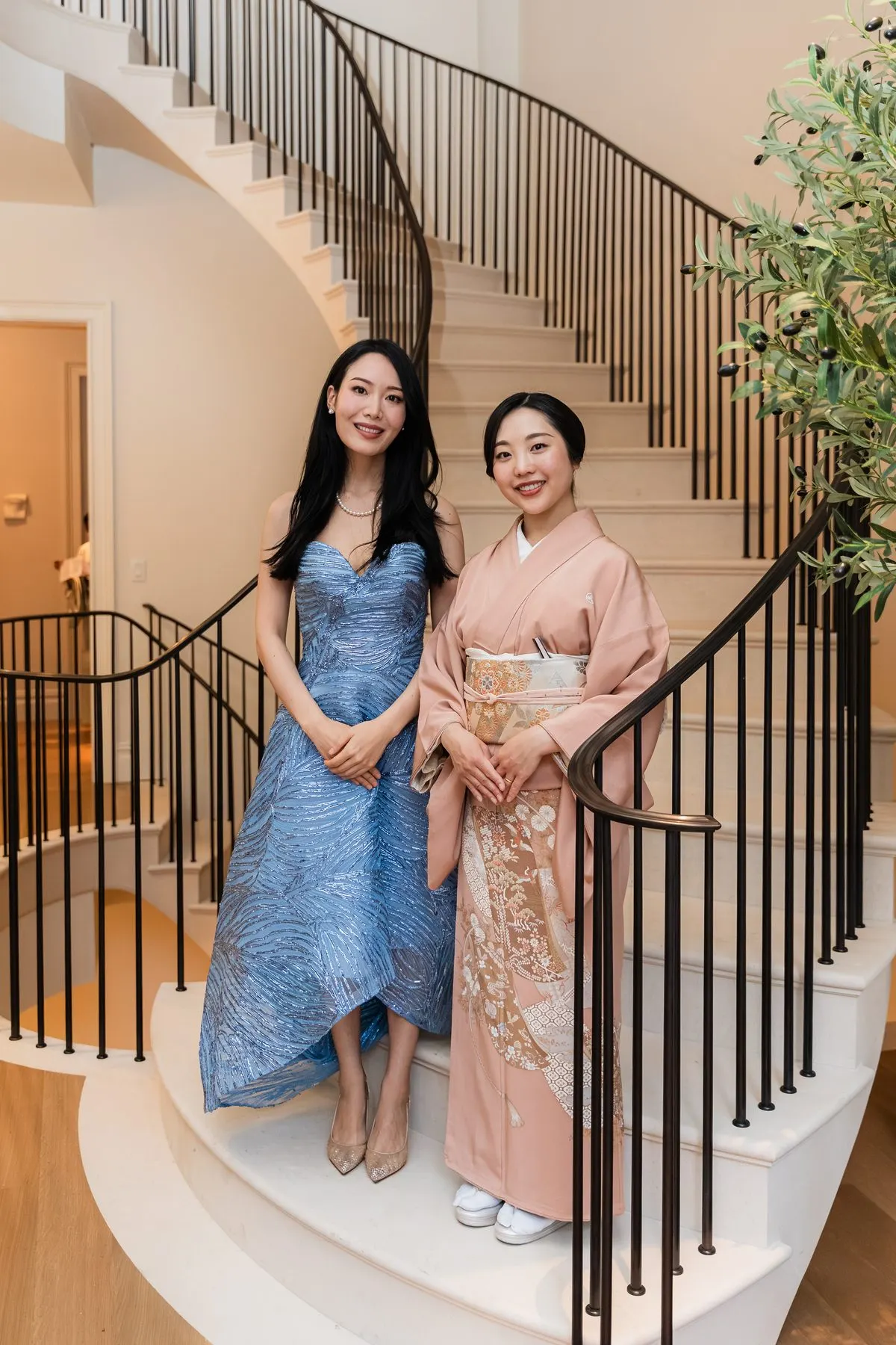 Rieko and a host in pink kimono on the spiral staircase