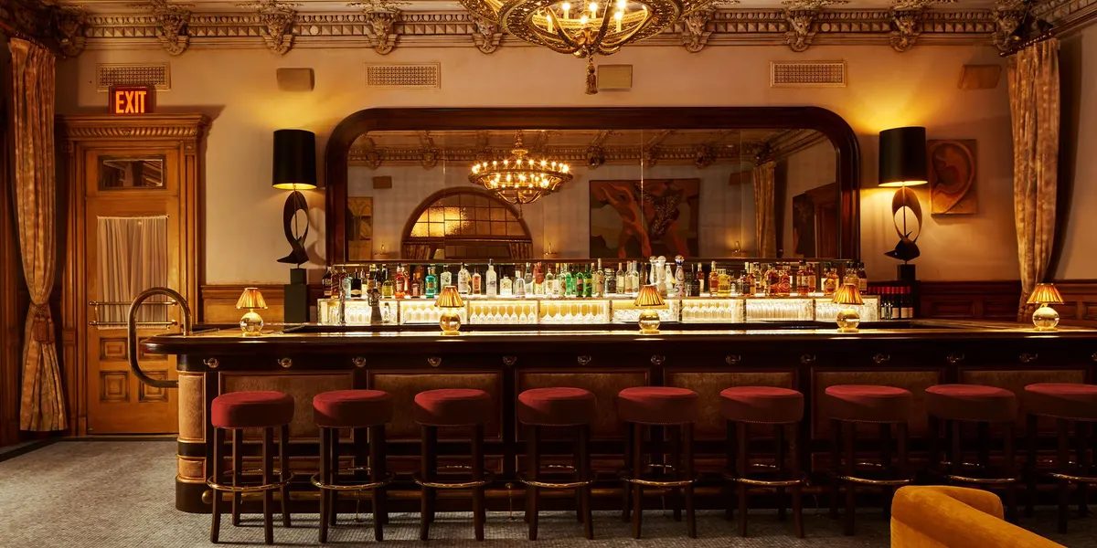 The Lobby Bar of The Hotel Chelsea: the marble bar, chandeliers and panelled walls